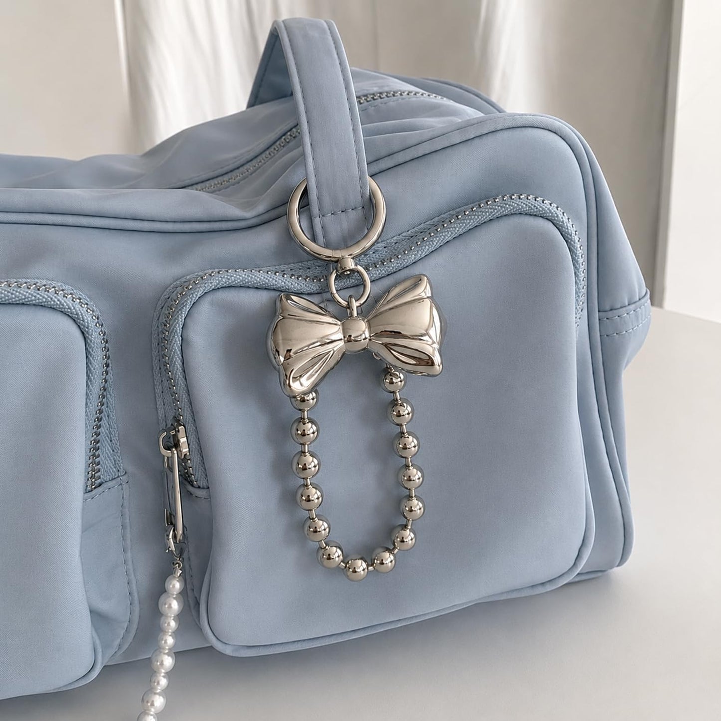 S.A.V.I Bow Keychain for Women, Silver Metal Bag Charm with Bead Chain, Round clasp accessory for handbags, backpacks & keys; stylish gift with glossy finish for girls and teens.
