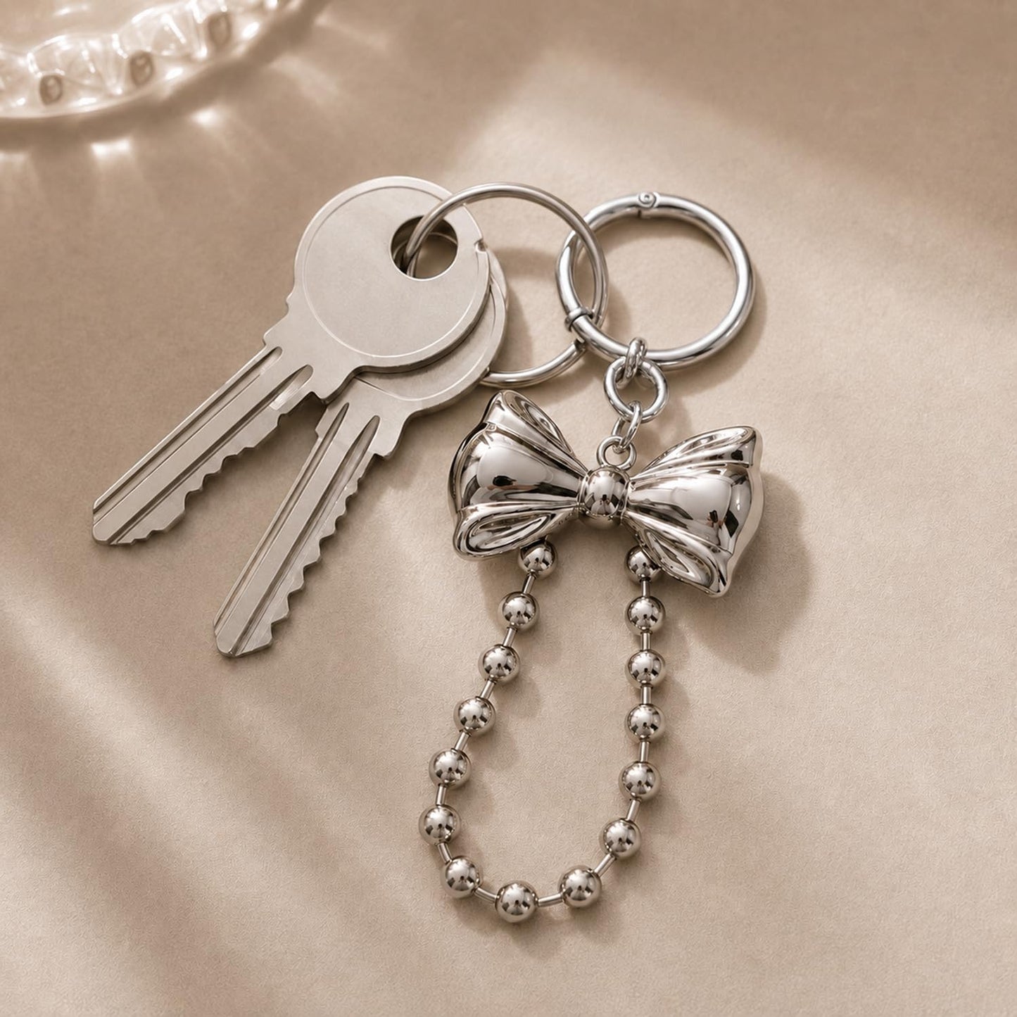 S.A.V.I Bow Keychain for Women, Silver Metal Bag Charm with Bead Chain, Round clasp accessory for handbags, backpacks & keys; stylish gift with glossy finish for girls and teens.