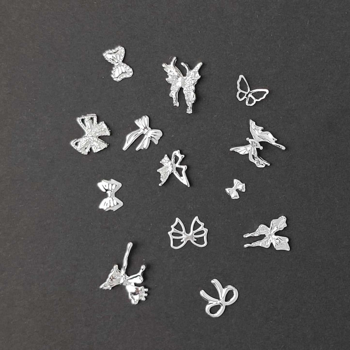 S.A.V.I Silver Metal 3D Nail Art Charms Set (60 Pcs) with Fairy, Butterfly & Bow Designs | DIY Decorations for Gel & Acrylic Nails | Flower Shape Round Storage Box 8.3 cm